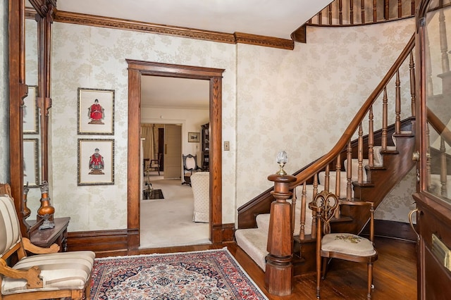 entrance foyer with stairs, wood finished floors, and wallpapered walls