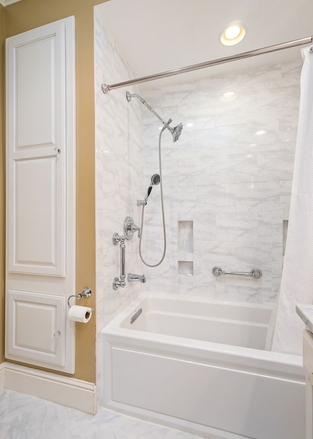 bathroom featuring marble finish floor, shower / tub combo with curtain, and vanity