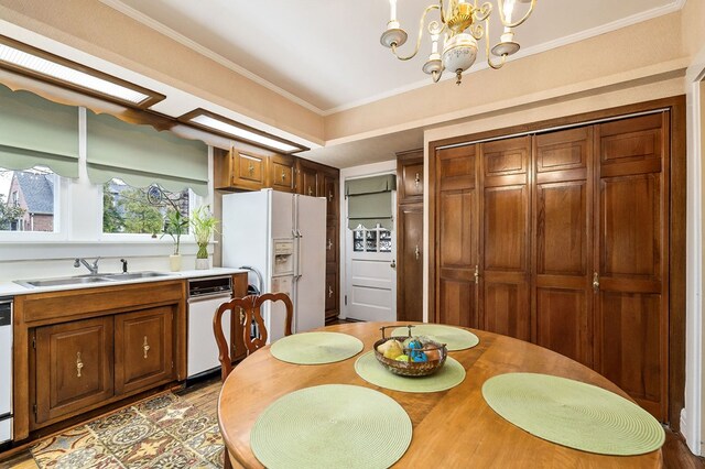 dining space featuring a chandelier and crown molding