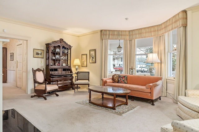 living area featuring ornamental molding and light colored carpet