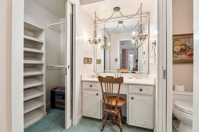 bathroom with a closet, crown molding, vanity, and toilet