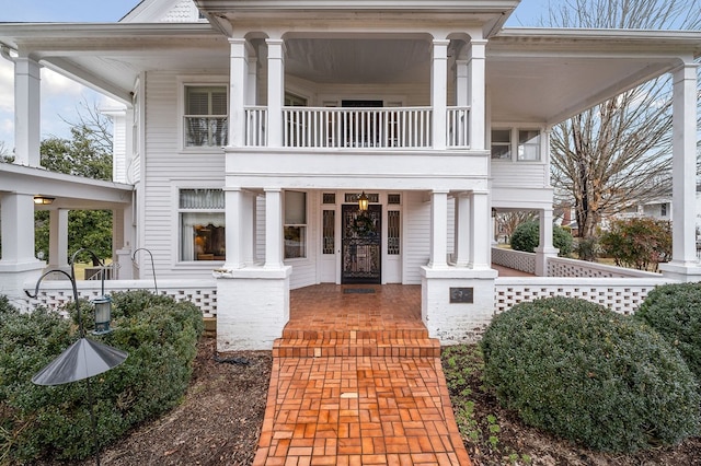 view of front facade featuring covered porch and a balcony