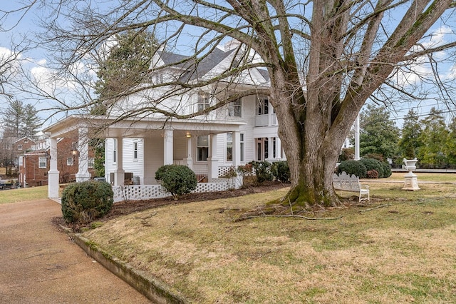 view of front of home with a front lawn and a porch