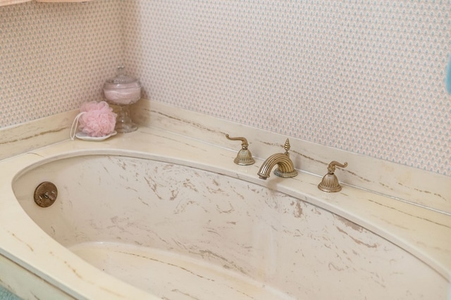 interior space featuring a sink and wallpapered walls