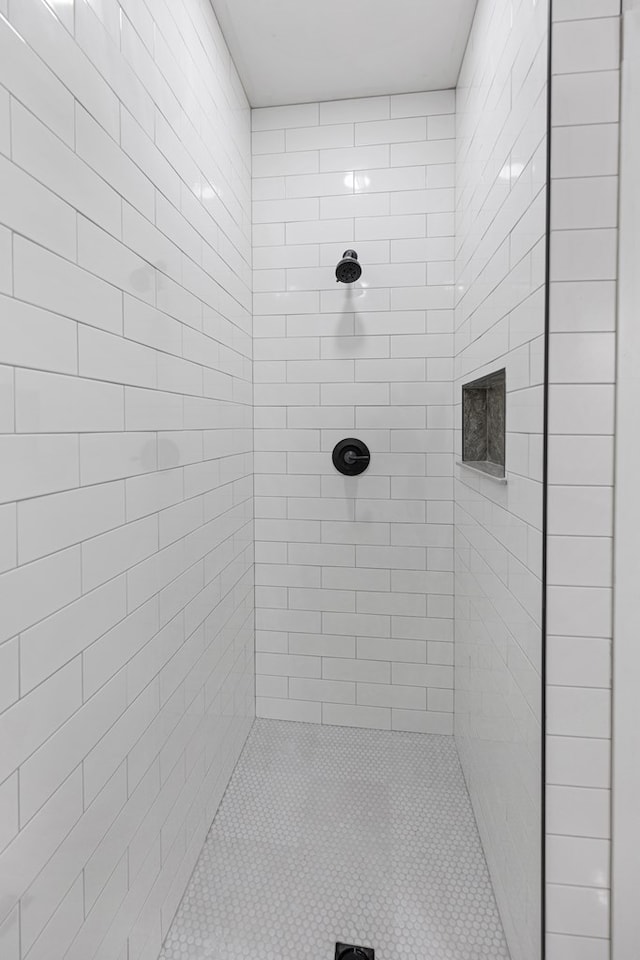 full bath with a tile shower