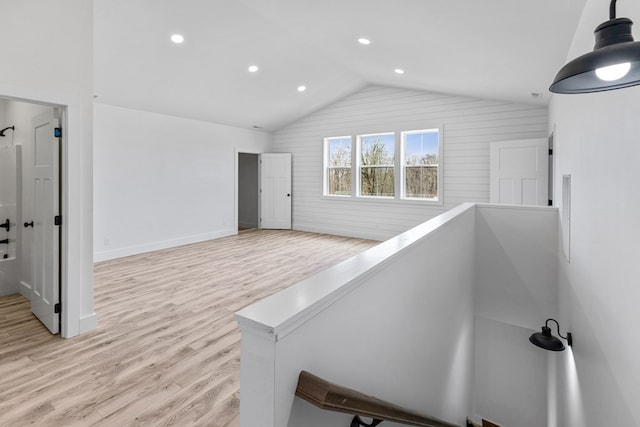 hallway featuring lofted ceiling, recessed lighting, an upstairs landing, baseboards, and light wood-type flooring