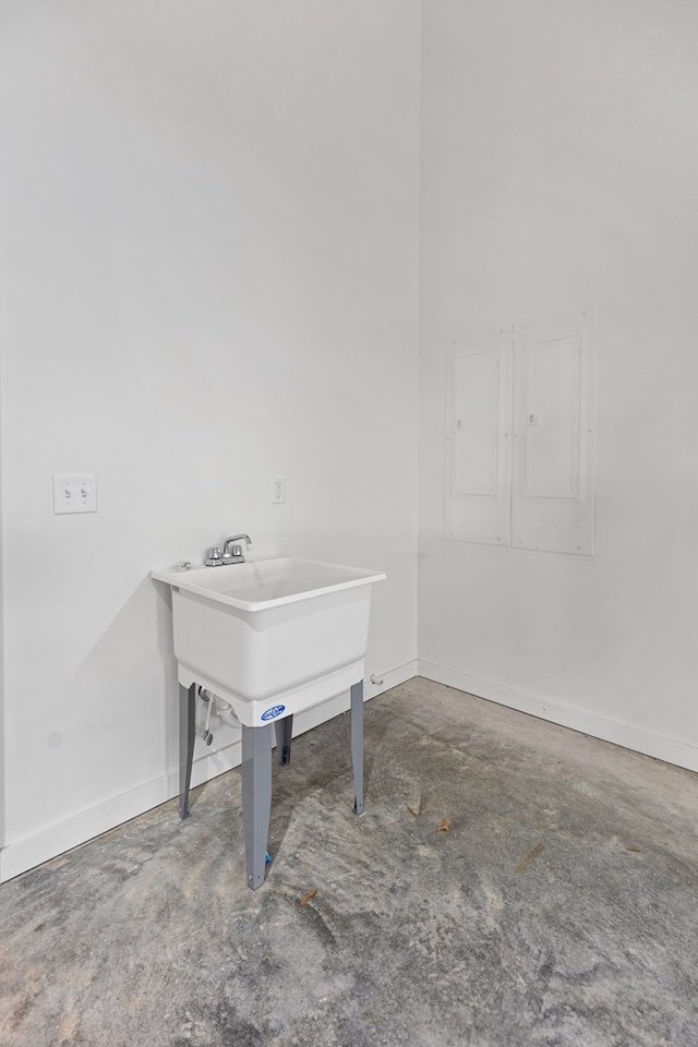 interior space featuring unfinished concrete flooring and baseboards