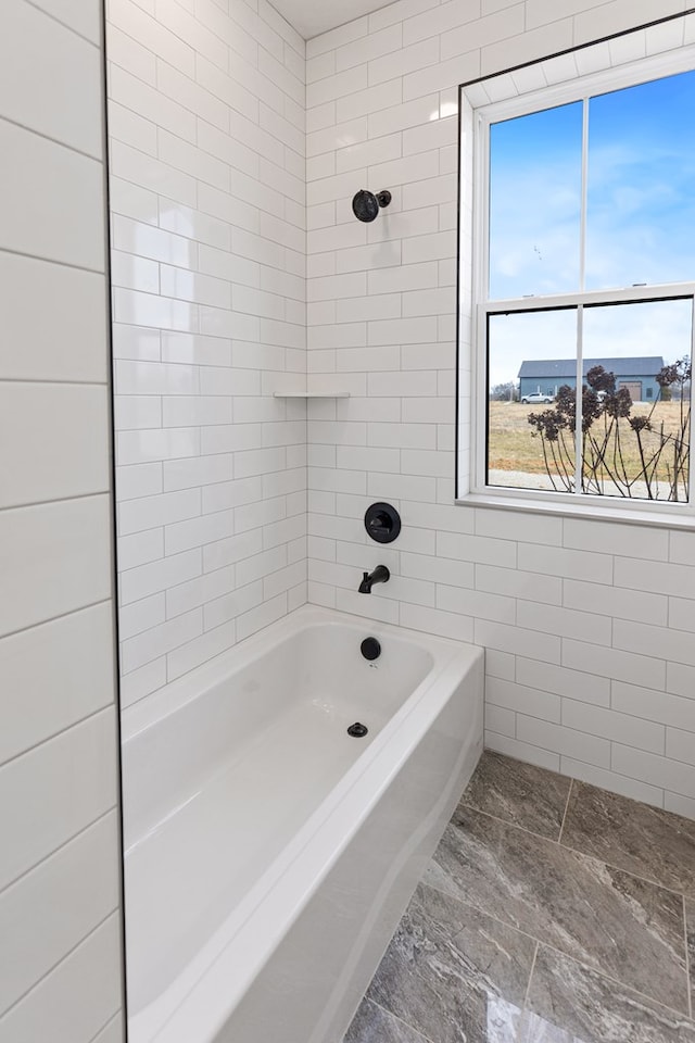 bathroom featuring bathtub / shower combination and tile walls