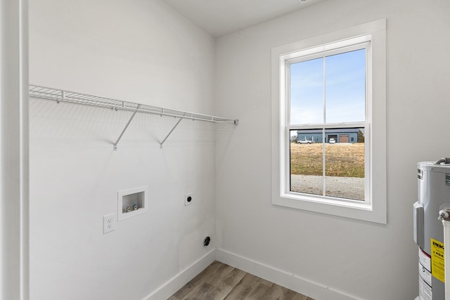 laundry room with hookup for an electric dryer, laundry area, washer hookup, baseboards, and water heater