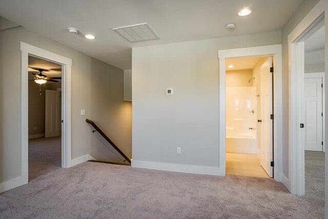 unfurnished room featuring recessed lighting, light colored carpet, visible vents, and baseboards