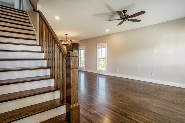 interior space featuring ceiling fan with notable chandelier, recessed lighting, wood finished floors, and baseboards