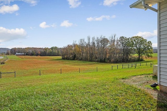 view of yard with a rural view and fence