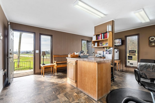 kitchen featuring baseboards, stone finish floor, brown cabinets, light countertops, and open shelves