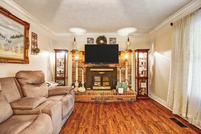 living room with dark wood-style flooring, visible vents, baseboards, ornamental molding, and a brick fireplace