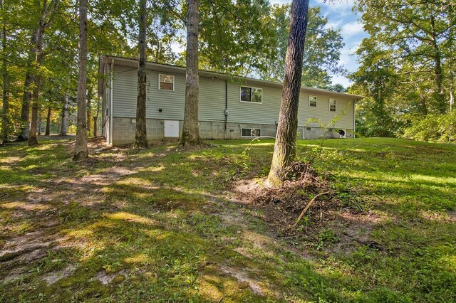 rear view of property with a lawn