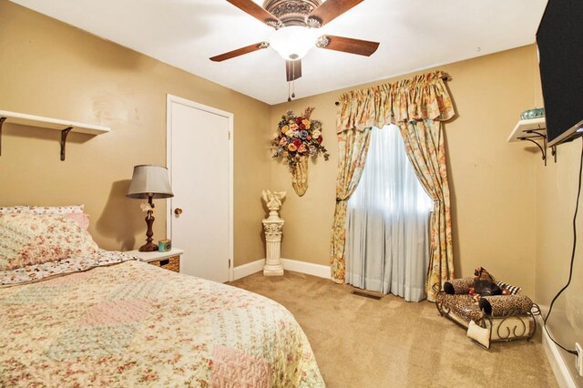 carpeted bedroom with baseboards, visible vents, and ceiling fan