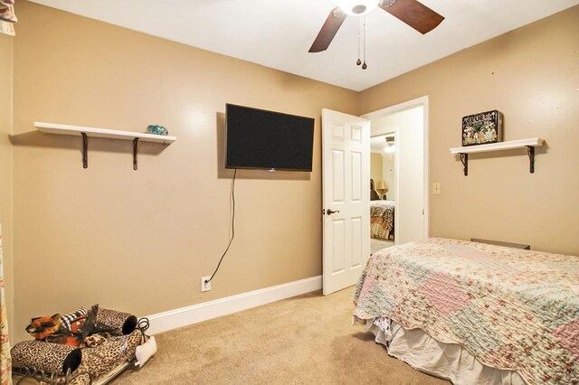 carpeted bedroom featuring ceiling fan and baseboards