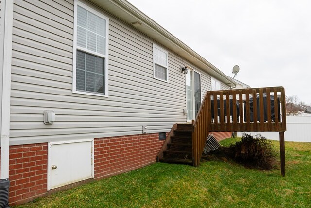 view of property exterior featuring crawl space, a lawn, and a wooden deck