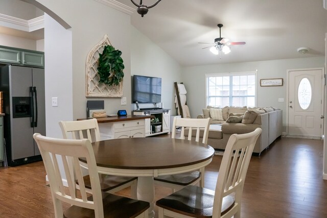 dining area featuring dark wood-style floors, arched walkways, ceiling fan, and lofted ceiling