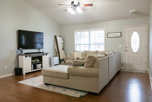 living area featuring lofted ceiling, dark wood-style floors, ceiling fan, and baseboards