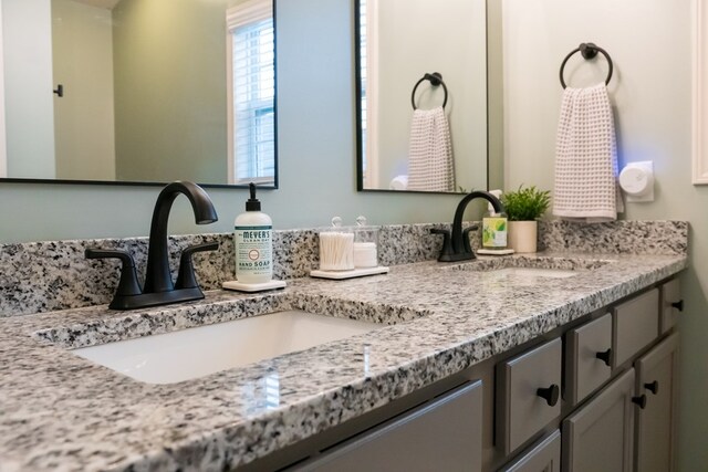 bathroom with double vanity and a sink