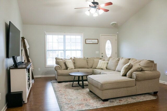 living room featuring a healthy amount of sunlight, a ceiling fan, dark wood-style flooring, and lofted ceiling