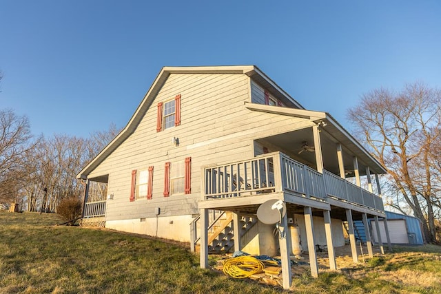 rear view of house with a wooden deck, a ceiling fan, stairs, and an outdoor structure