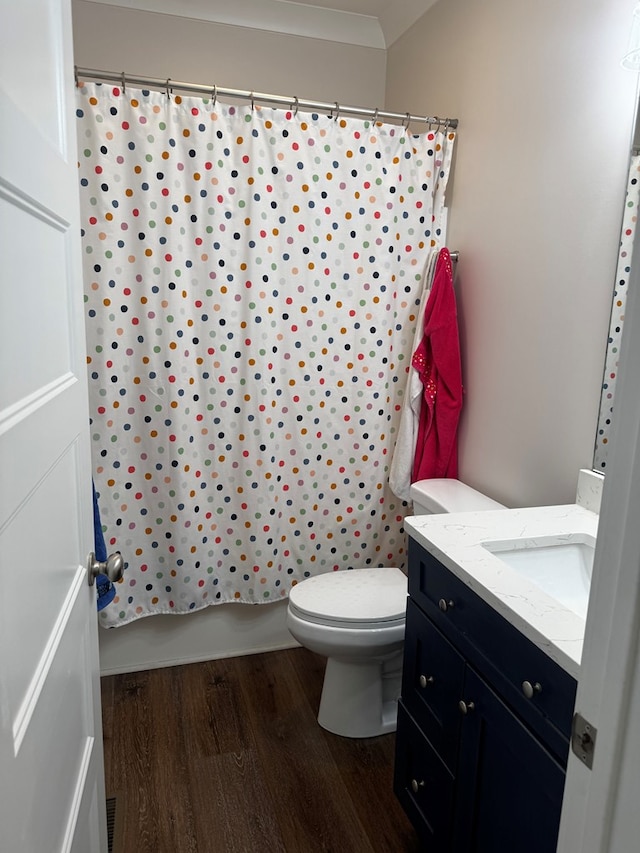 bathroom with toilet, wood finished floors, and vanity