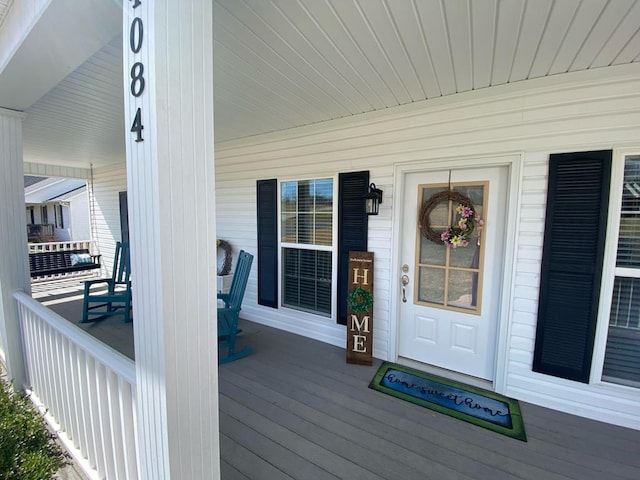 view of exterior entry with a porch