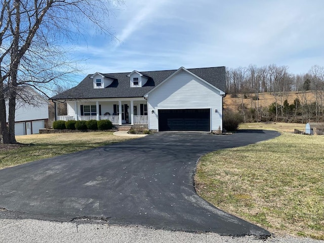 view of front of home featuring roof with shingles, a porch, a garage, driveway, and a front lawn