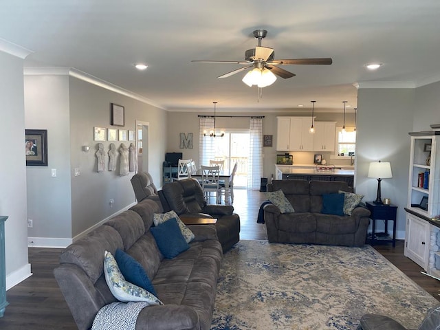 living area featuring dark wood-type flooring, crown molding, and baseboards