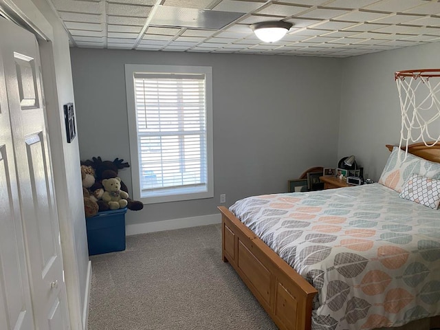 bedroom featuring light carpet and baseboards