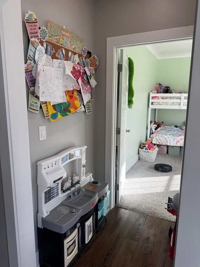 interior space featuring baseboards, ornamental molding, and dark wood finished floors