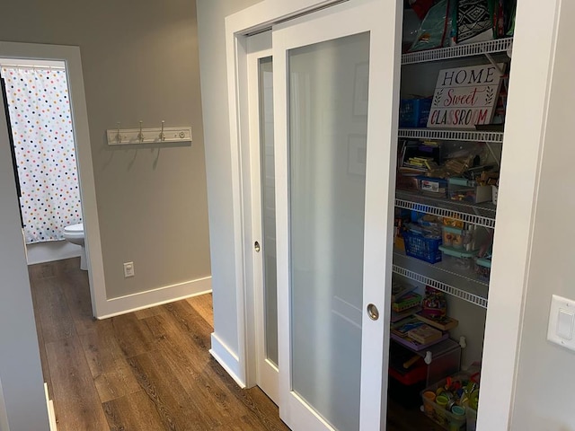 interior space featuring dark wood-style floors and baseboards