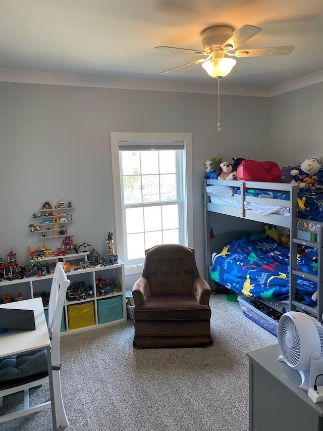 bedroom featuring a ceiling fan, carpet flooring, and crown molding