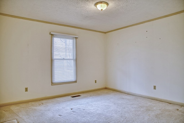 carpeted empty room featuring ornamental molding, visible vents, a textured ceiling, and baseboards