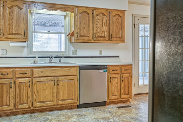 kitchen featuring a sink, visible vents, light countertops, stainless steel dishwasher, and brown cabinets