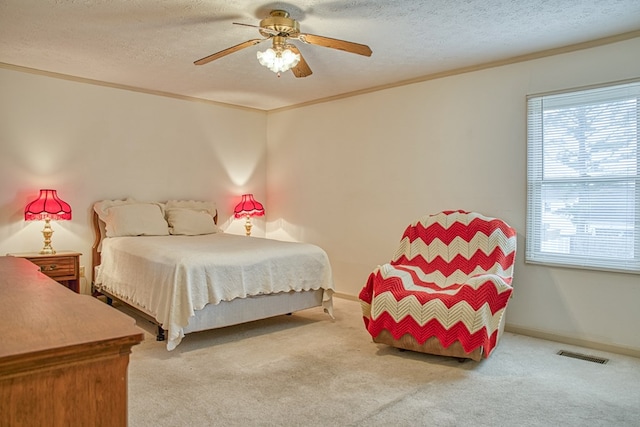 bedroom featuring light carpet, a textured ceiling, visible vents, and crown molding