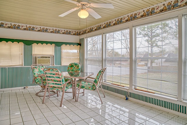 unfurnished sunroom with ceiling fan and cooling unit