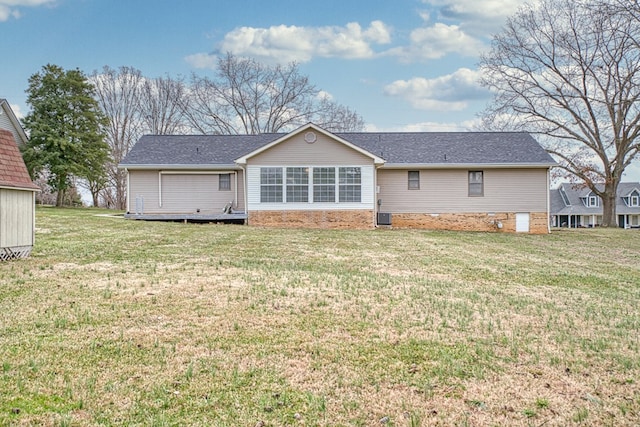 back of property featuring a lawn