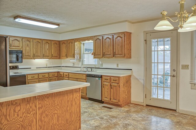 kitchen with stainless steel appliances, a textured ceiling, light countertops, pendant lighting, and a sink