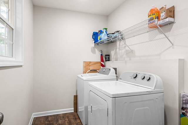 clothes washing area featuring laundry area, baseboards, washer and clothes dryer, and dark wood-style flooring