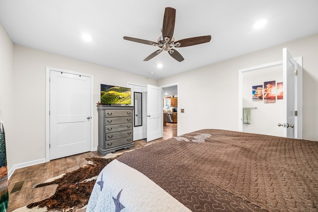 bedroom with baseboards, a ceiling fan, wood finished floors, two closets, and recessed lighting