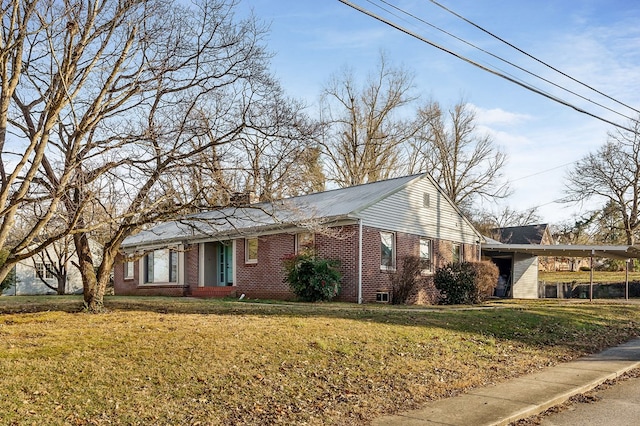 single story home with an attached carport, a front yard, brick siding, and a chimney