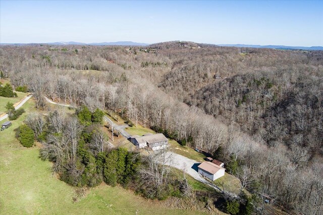 drone / aerial view featuring a wooded view