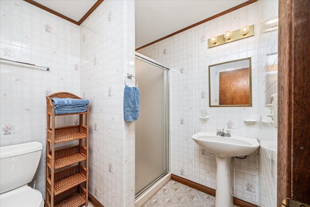 bathroom with ornamental molding, tile walls, a shower stall, and toilet