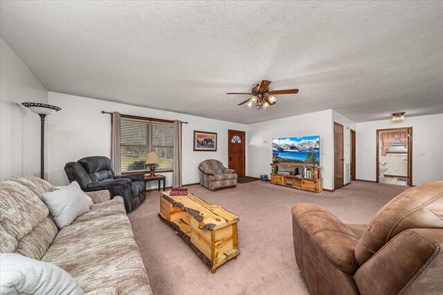 living room featuring a textured ceiling, a ceiling fan, and carpet flooring