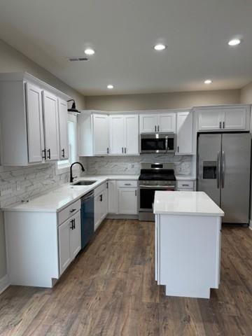 kitchen featuring a sink, white cabinetry, stainless steel appliances, and light countertops