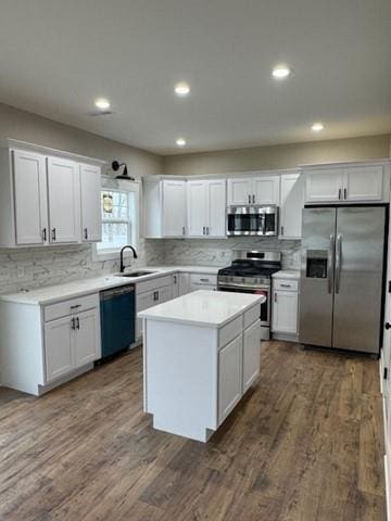 kitchen featuring a sink, white cabinetry, stainless steel appliances, and light countertops