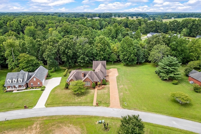 birds eye view of property with a forest view